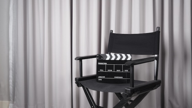 Clapper board or movie slate with black director chair use in video production movie cinema industry