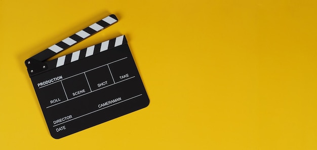 Clapper board or movie slate on yellow background