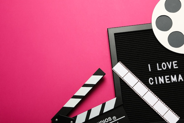 Clapperboard reel film and letter board on pink background space for text