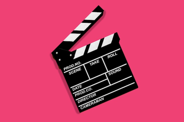 Clapperboard for shooting video footage takes on a pink background