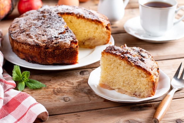 Clasic sponge cake with apples on table selective focus Homemade cake