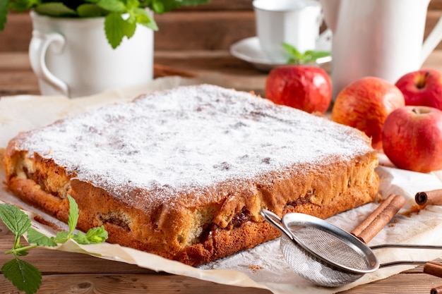 Clasic sponge cake with apples on table selective focus Homemade cake