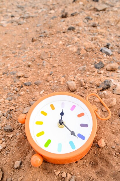 Classic Analog Clock In The Sand On The Rock Desert