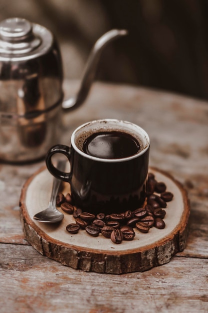 Classic black coffee plating with coffee beans on the wooden plate