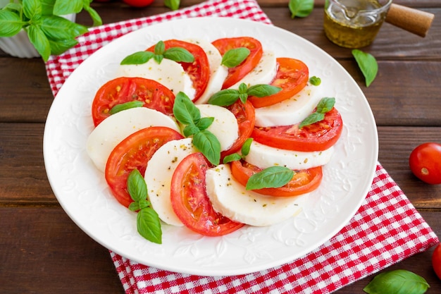 Classic caprese salad with mozzarella cheese tomatoes and basil Top view copy space