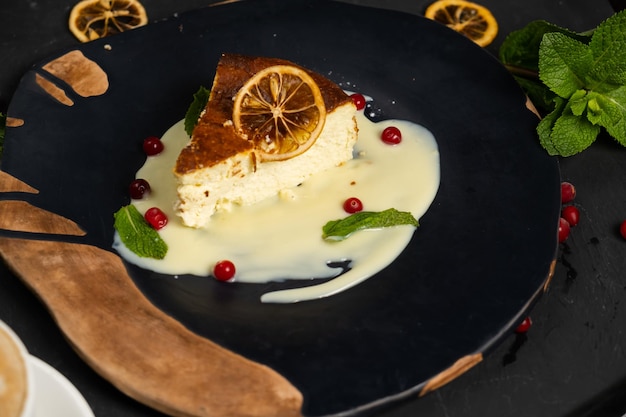 Classic cheesecake on a black background dessert on a black background in a black plate