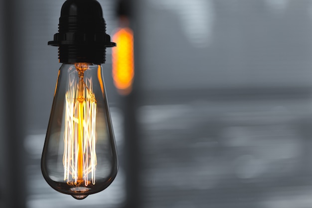 A classic Edison light bulb on dark background 