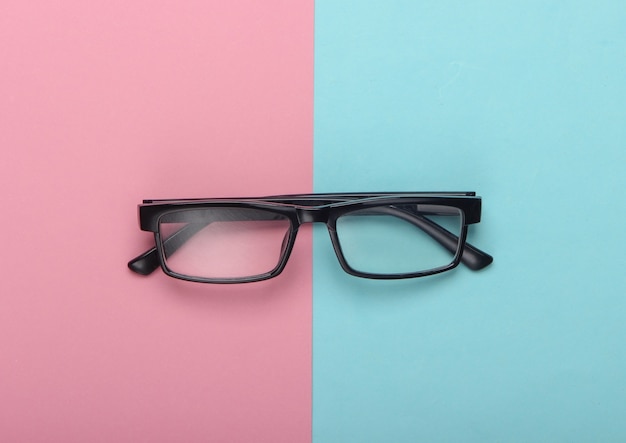 Classic eyeglasses on pink blue pastel.