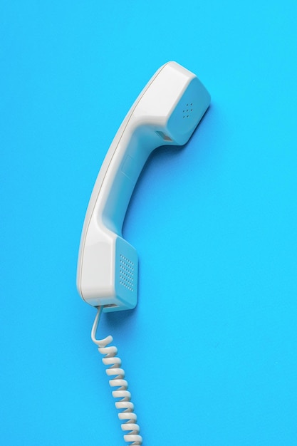 Classic handset with a wire on a blue background