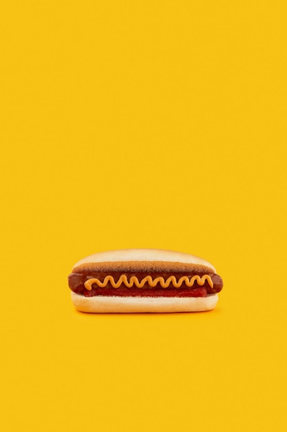 Classic hot dog with wurst ketchup and mustard on orange background Menu for restaurant