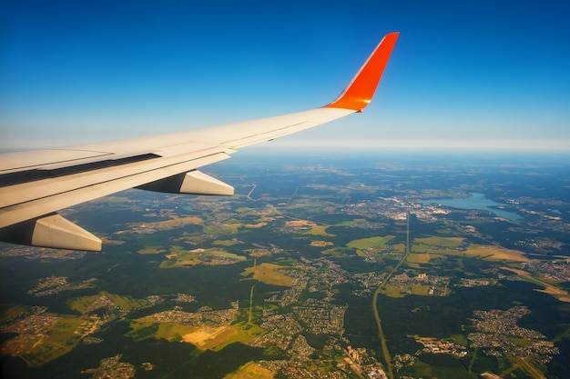 Classic image through aircraft window onto wing flight view over russia