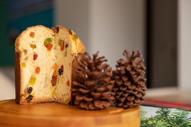 Photo classic italian panettone on a table decorated with pine cones waiting for christmas