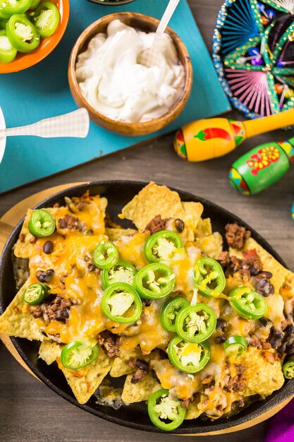 Classic nachos with ground beef and fresh jalapeno chili peppers.