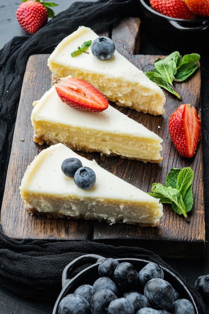 Classic New York Cheesecake, sliced, on black table