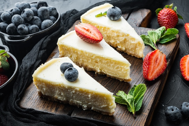 Classic New York Cheesecake, sliced, on black