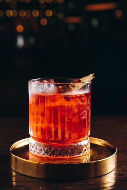 Classic old fashioned Cocktail in a retro glass with ice and pineapple slice