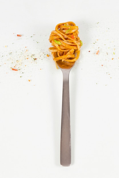 Classic pasta with tomato sauce on fork.