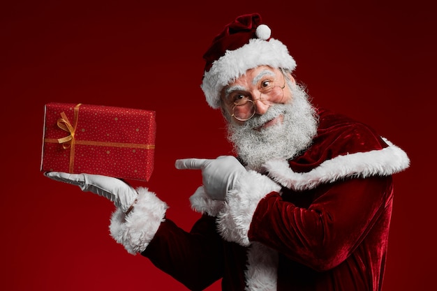 Classic Santa Holding Red Christmas Present