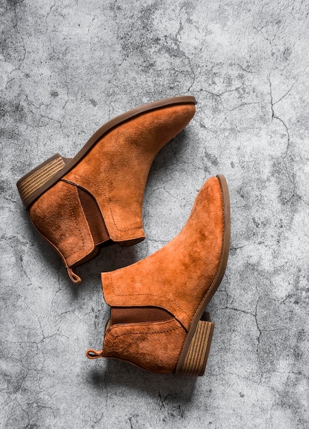 Classic suede brown women's chelsea boots on a gray background top view