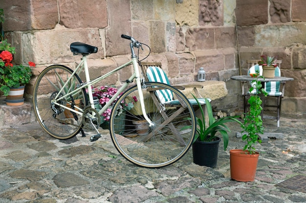 Classic touring bicycle parked in a beautiful courtyard of a rural house