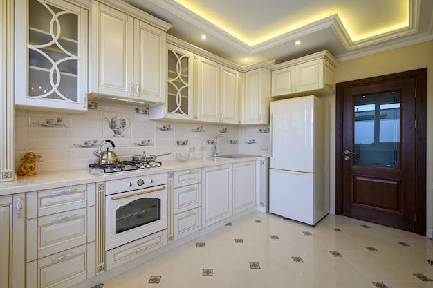 Classic white and beige large luxurious kitchen in studio apartment