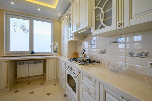 Classic white and beige large luxurious kitchen in studio apartment