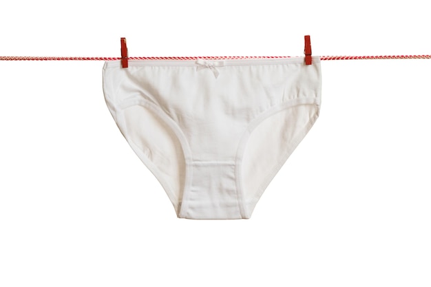 Classic women's white panties on a red clothesline isolated on a white background