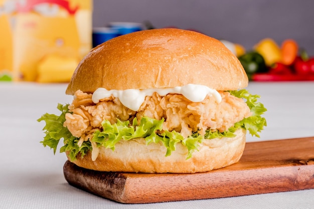 Classic Zinger burger Meal isolated on wooden board side view on grey background fastfood