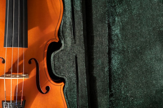 Classical music concert poster with orange color violin on green background with copy space for your