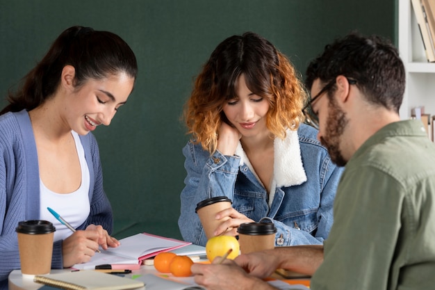 Classmates taking notes during study session