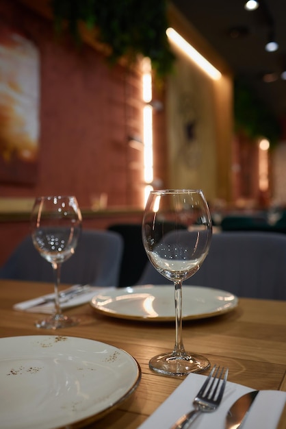 Classy table with a bouquet Luxury dining set with cutlery serviette crockery and covered with a tablecloth in restaurant