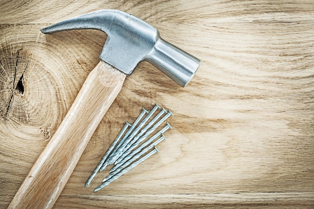 Claw hammer nails on wooden board building concept