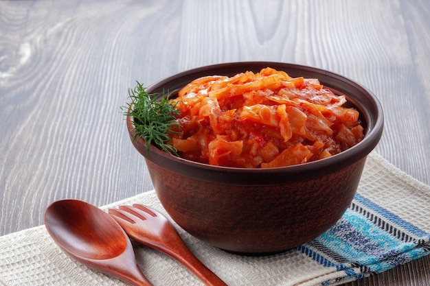 In a clay bowl cabbage stewed with tomatoes