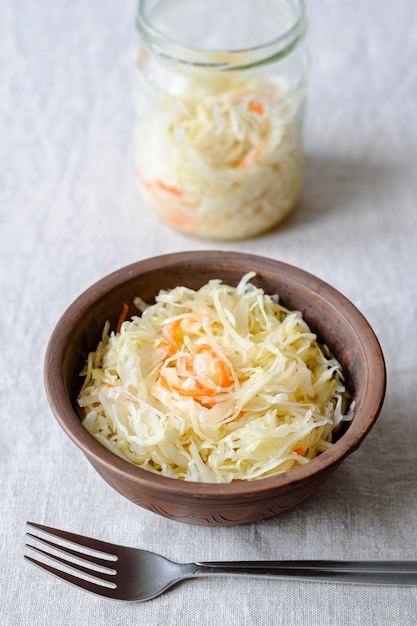 Clay bowl with fermented cabbage snack