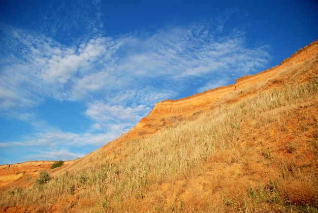 Clay mountain on a background of blue sky