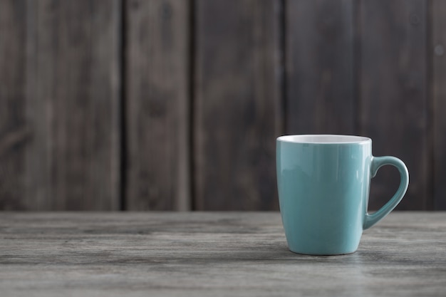 Clean cup on old wooden background