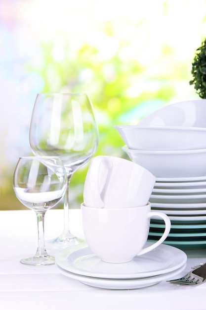 Clean dishes on table on natural background