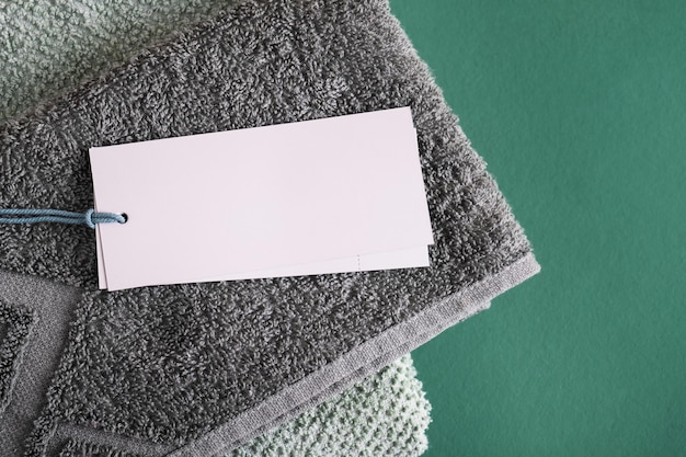 Clean folded towels with empty blank tag for text