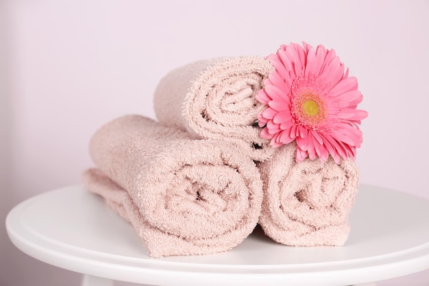 Clean rolled towels and beautiful flower on table