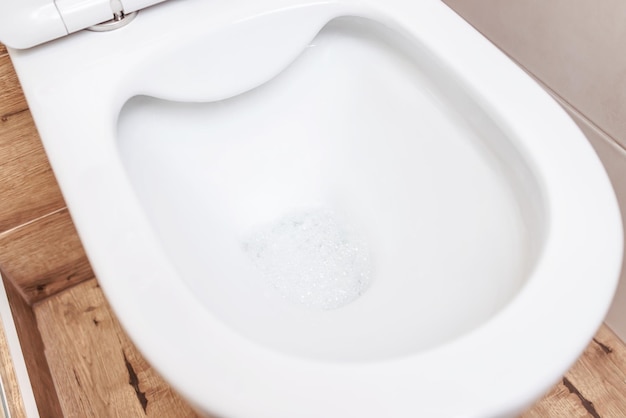 Clean white new toilet closeup in the bathroom