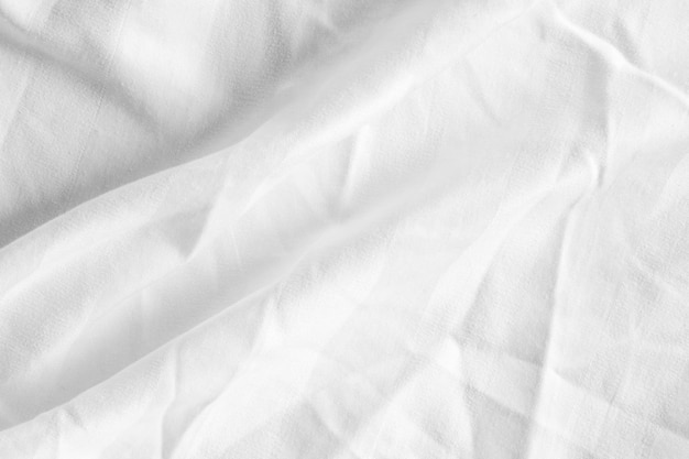 Clean white paper wrinkled background abstract crumpled white paper white bed linen gradient texture blurred curve style of abstract luxury fabricWrinkled bed linen and dark gray shadowsbackground