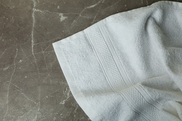 Clean white towel on gray textured