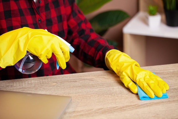 Cleaner tidies up the computer desk in the office