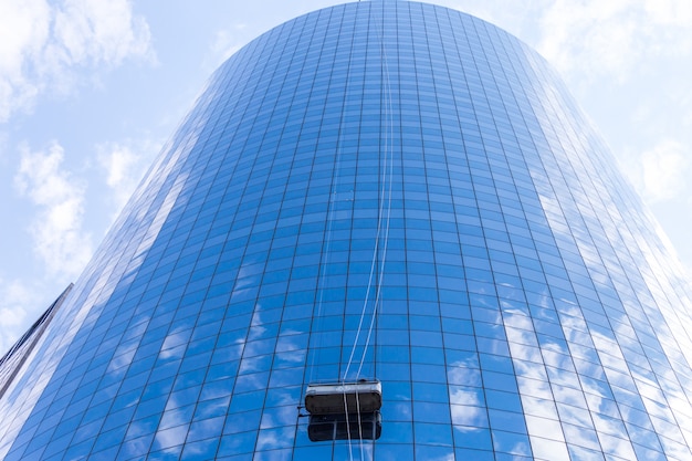 cleaners washing the windows of modern skyscraper