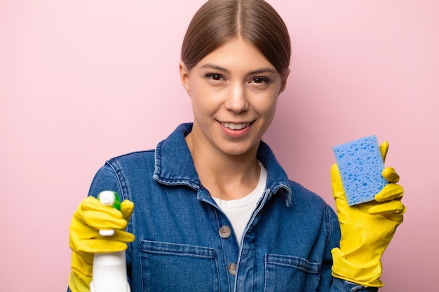 Cleaning company worker in overalls yellow gloves and cleaning supplies