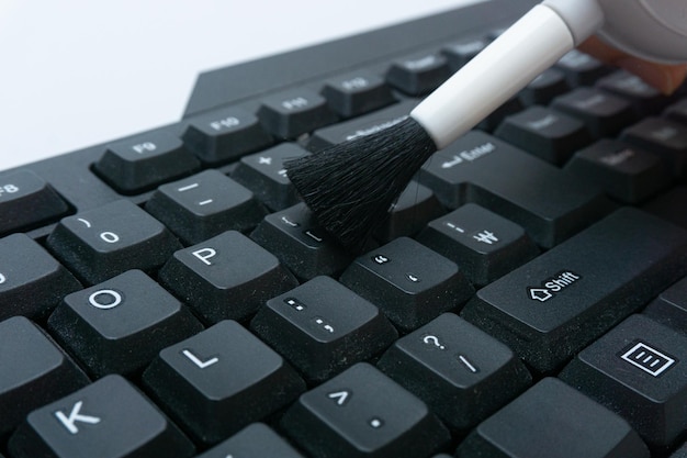 Cleaning the computer keyboard with various cleaning tools