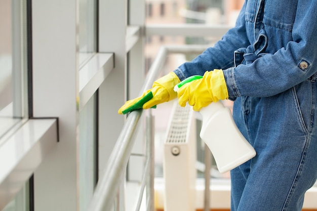 Cleaning concept young woman with supplies cleaning office