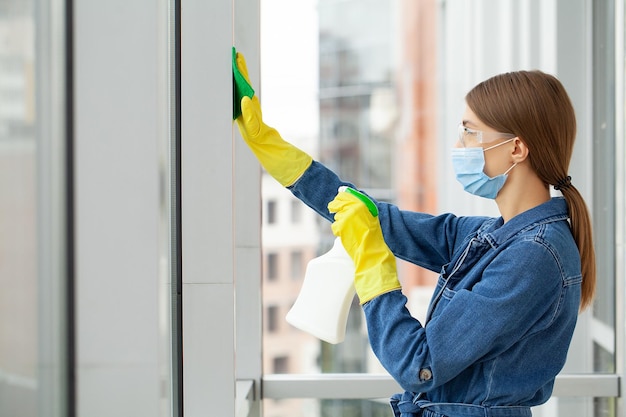 Cleaning concept young woman with supplies cleaning office