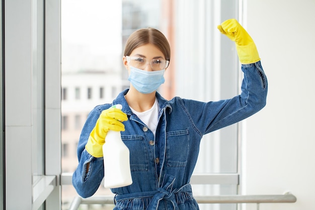 Cleaning concept young woman with supplies cleaning office