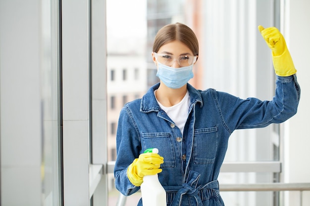 Cleaning concept young woman with supplies cleaning office